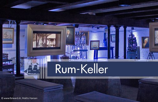 I romkælderen står der betonbænke, som man kan sidde på. Fra loftsbjælkerne hænger der skærme, hvor der vises en film om købmændene i Flensborg. I den bageste del af rummet hænger der malerier fra loftet, hvor man kan se sejlskibe og personer. Der står også forskellige apparater til aftapning af rom i dette rum.